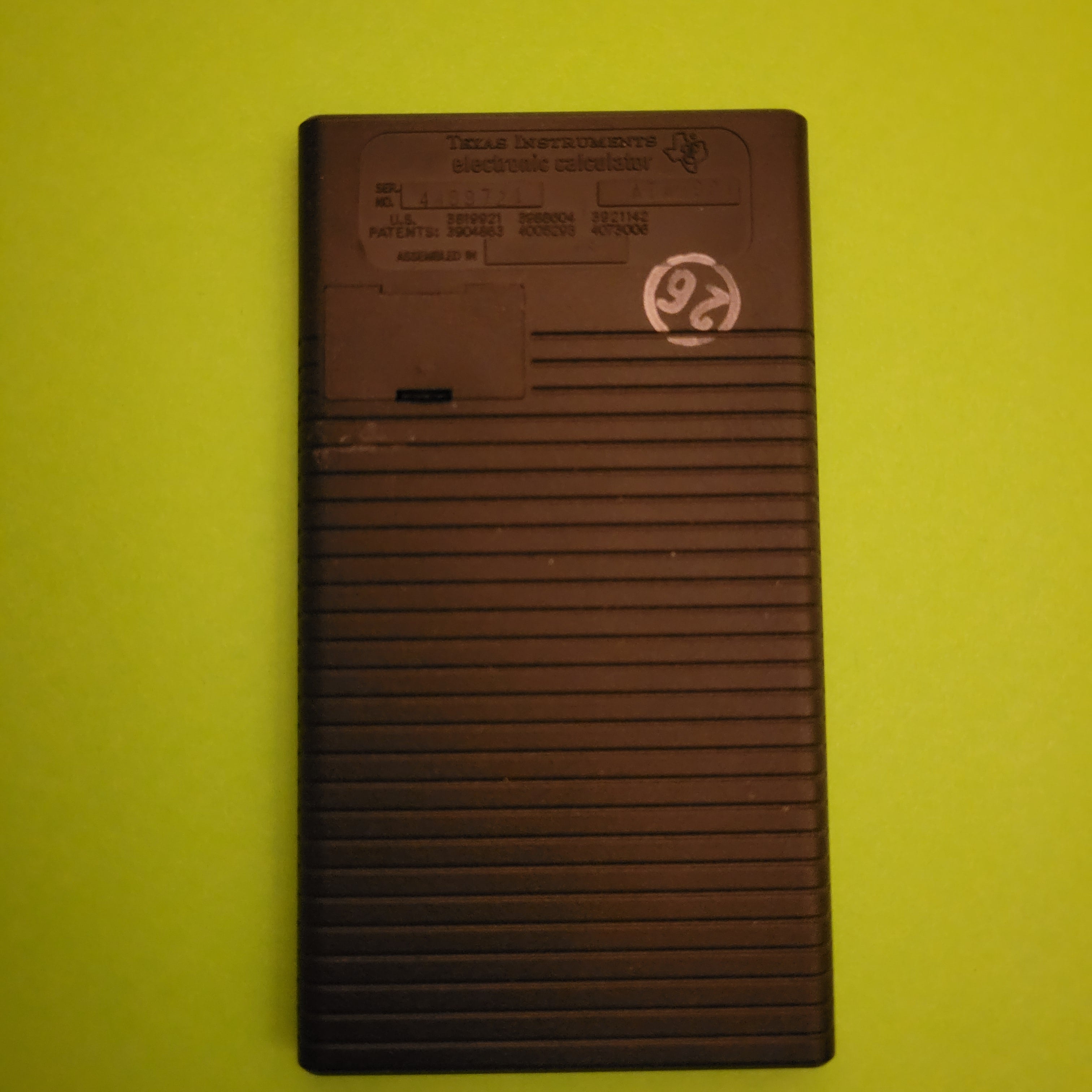 An image of the back of a Ti converter four function plus calculator